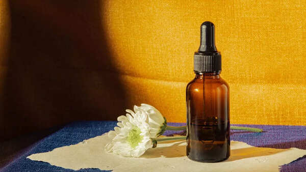 Close-up of hair serum being applied