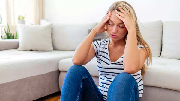 A person looking unwell, potentially experiencing symptoms of vitamin B12 deficiency