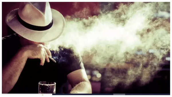 A cigarette and an alcoholic beverage with a crossed-out symbol