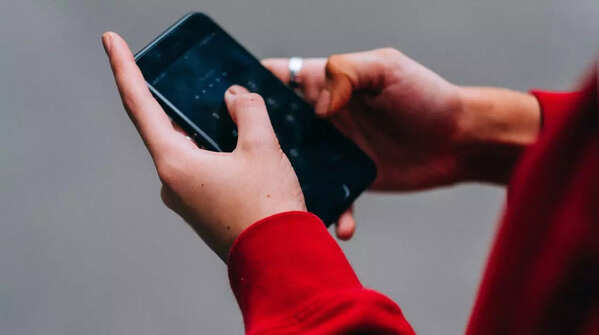 Image of holding phone with two hands, scrolling with both thumbs.