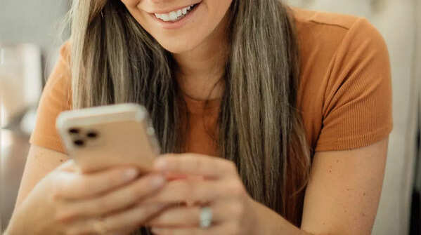 Image of holding phone with two hands, scrolling with one thumb.